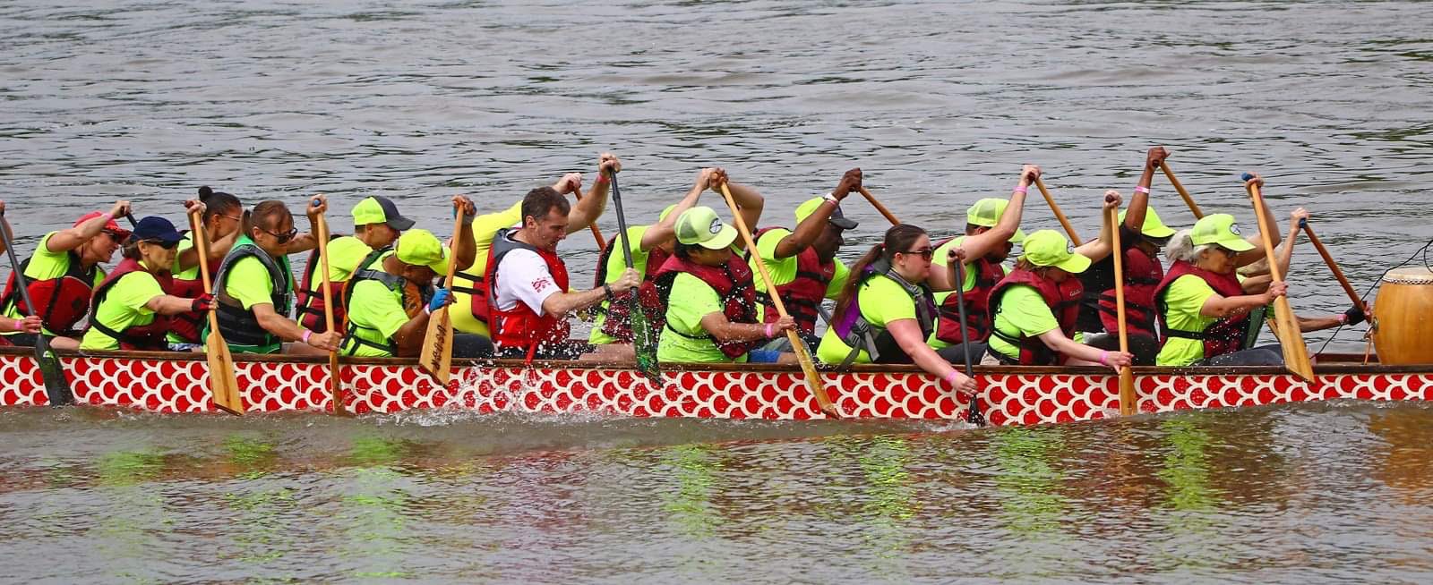Full length view of team OSD in a dragon boat on the Potomac.